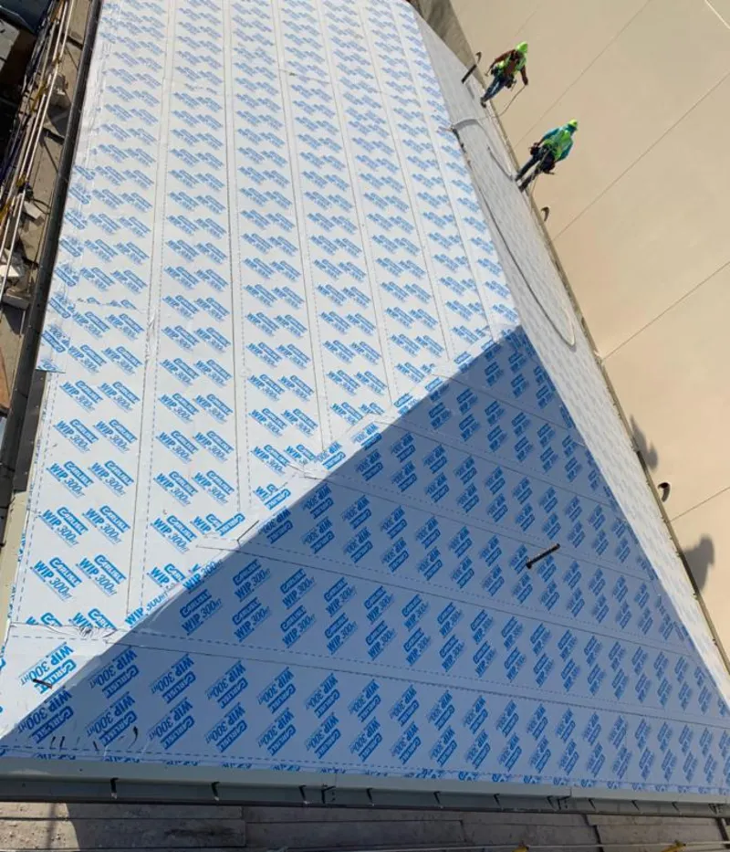 Professional roofers installing underlayment on a metal roof in Wheelersburg